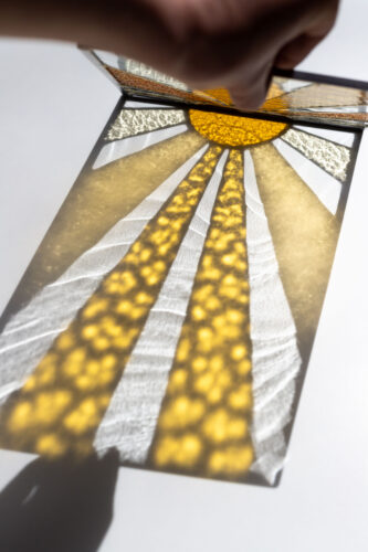 Decorative stained glass panel inspired by the sun, handmade art glass