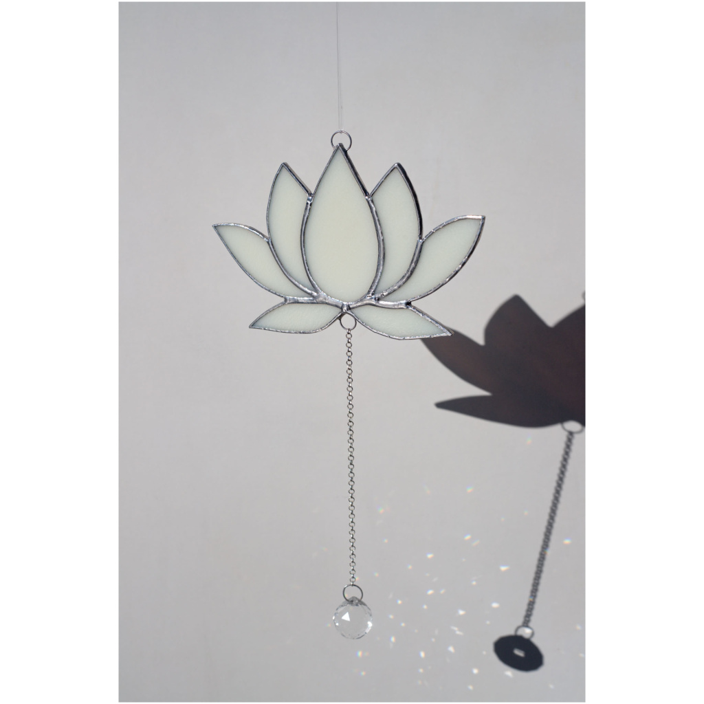 Hanging stained glass window suncatcher in a lotus flower shape made with Tiffany technique.
