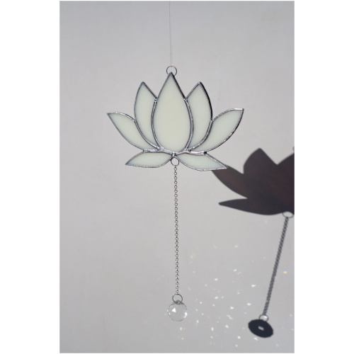 Hanging stained glass window suncatcher in a lotus flower shape made with Tiffany technique.