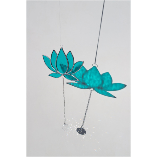 Hanging stained glass window suncatcher in a lotus flower shape made with Tiffany technique.