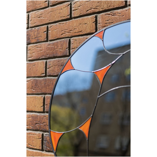Designer round stained glass mirror featuring a handcrafted fluid pattern and modern artisan metalwork by Duosglass.
